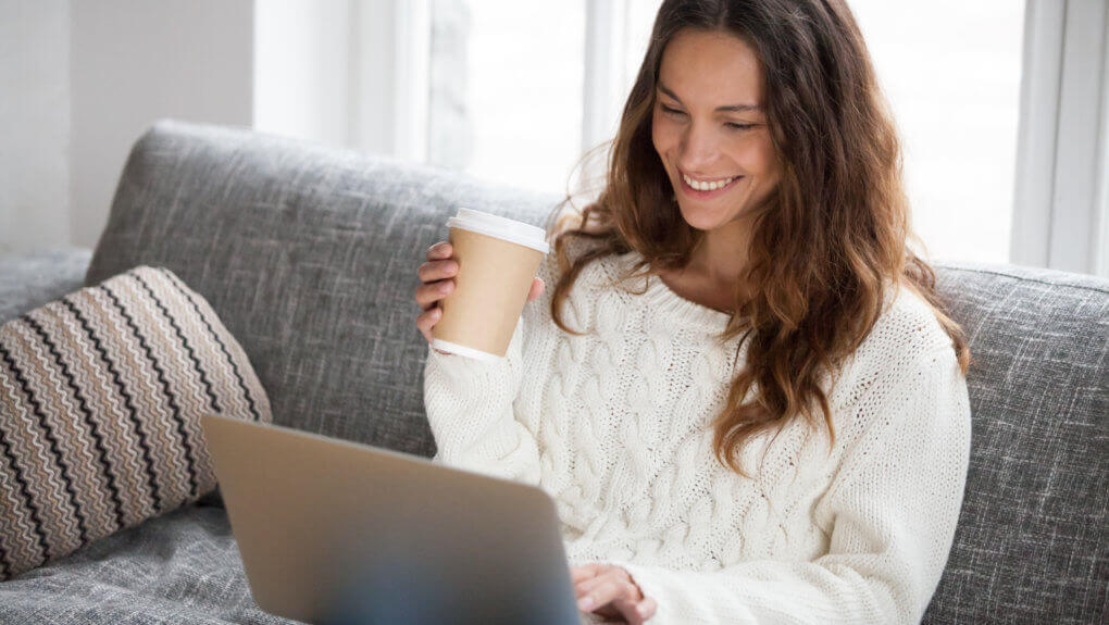 woman smiling at laptop