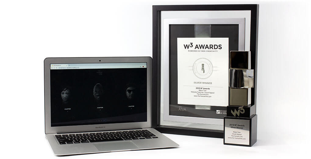 W3 Awards trophy opened laptop and the certificate