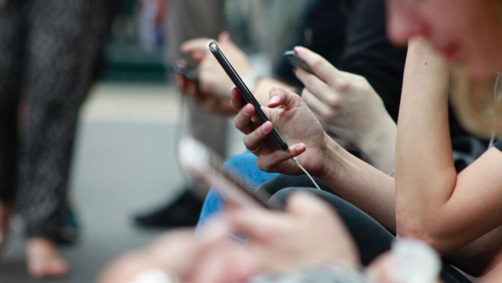 woman scrolling on mobile phone