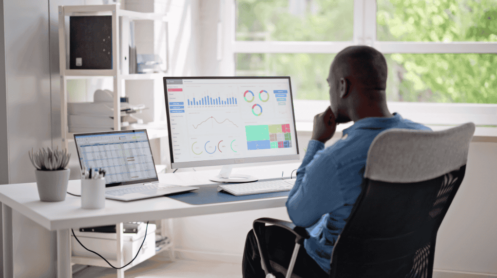 Man looking at SEO dashboard on screens