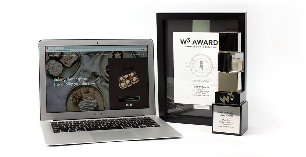 W3 Awards trophy opened laptop with Cobsbread website lodaed and the certificate