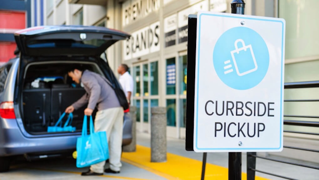 person picking up bags from curbside pickup