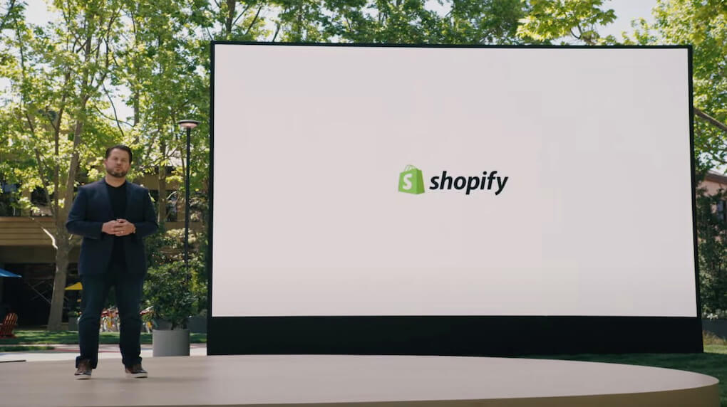 man presenting with shopify logo on screen