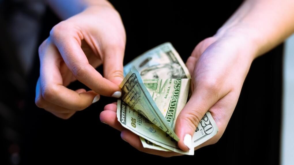 person holding cash money