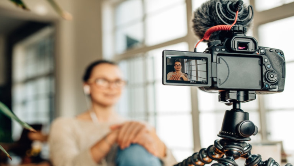 women filming herself with camera