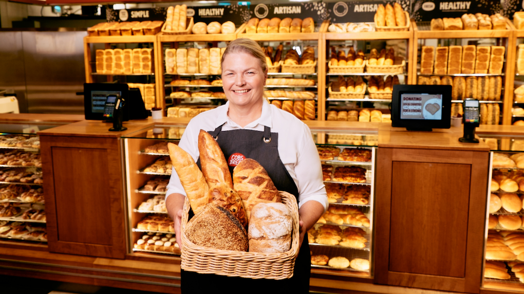 women holding a basket of bread